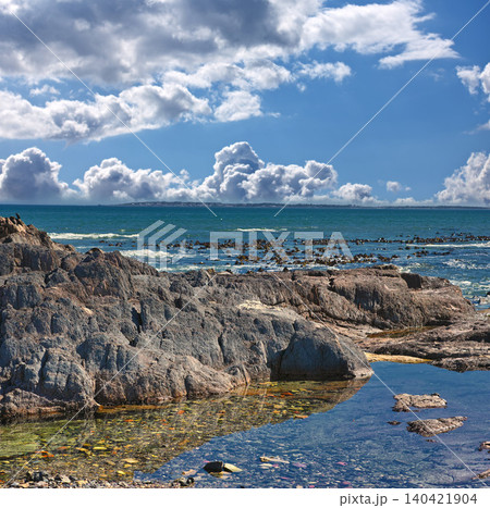 Rocks, ocean and landscape with nature, blue sky and clouds with coastline and outdoor travel destination. Surf, Earth and water with seascape, natural background and beach location in Cape Town Rocks, ocean and landscape with nature, blue sky and clouds with coastline and outdoor travel destination. Surf, Earth and water with seascape, natural background and beach location in Cape Town 140421904