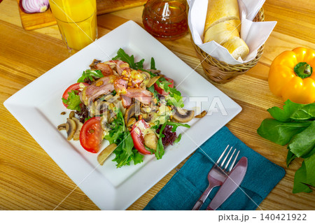 Fresh salad with vegetables and grilled meat served on a table with bread and a drink Fresh salad with vegetables and grilled meat served on a table with bread and a drink 140421922