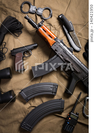 Items used for security and law enforcement, displayed on a brown cloth background Items used for security and law enforcement, displayed on a brown cloth background 140421950