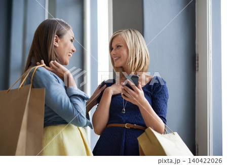 Friends, smile and shopping with smartphone in mall for bonding, communication and conversation in Paris. Women, happy and talk with technology in store for ecommerce, buying and discount on purchase Friends, smile and shopping with smartphone in mall for bonding, communication and conversation in Paris. Women, happy and talk with technology in store for ecommerce, buying and discount on purchase 140422026
