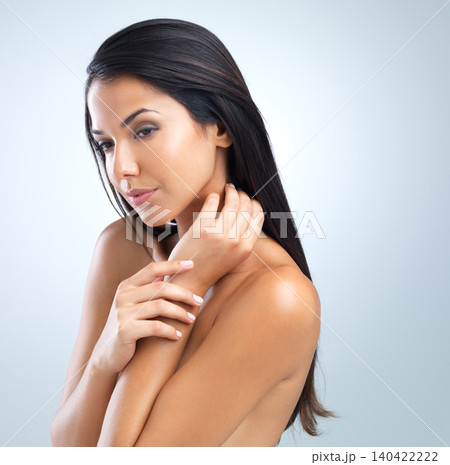 Woman, hair and beauty with cosmetics in studio, dermatology and wellness with keratin treatment on grey background. Haircare, shampoo and texture with growth, self care and cosmetology for shine 140422222