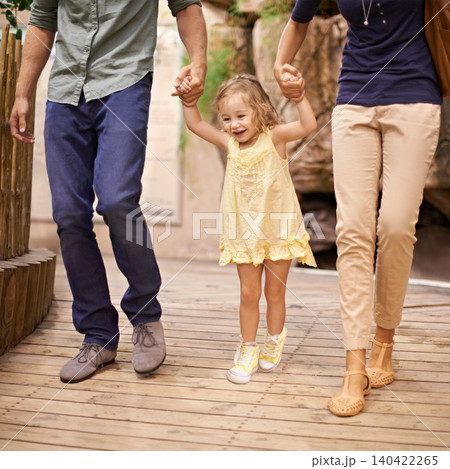 Happy, little girl and holding hands with parents for bonding, adventure or field trip. Excited child or kid walking with mom and dad in travel for fun holiday, weekend or sightseeing together Happy, little girl and holding hands with parents for bonding, adventure or field trip. Excited child or kid walking with mom and dad in travel for fun holiday, weekend or sightseeing together 140422265
