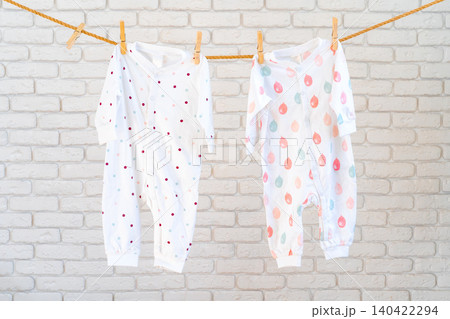 Washing of baby clothes pinned on a rope to dry 140422294