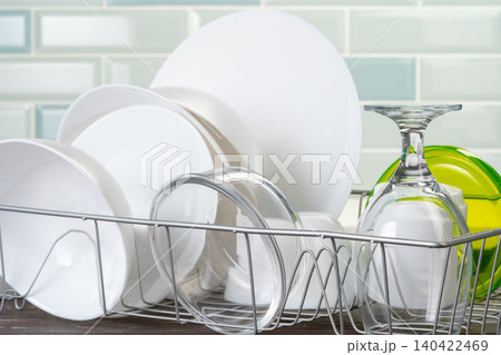 Dish rack with clean dry dishes on kitchen counter Dish rack with clean dry dishes on kitchen counter 140422469