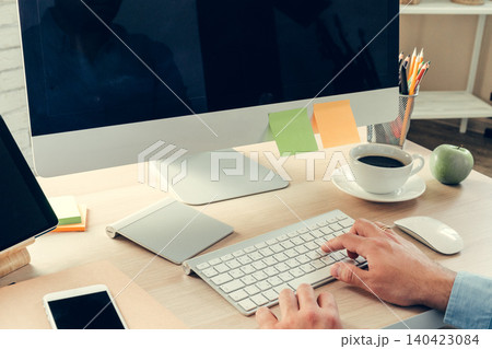 Office worker doing his job sitting at his working table with a computer Office worker doing his job sitting at his working table with a computer 140423084
