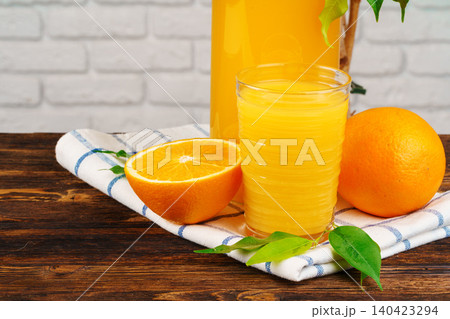 Glass of orange juice on wooden table close up 140423294