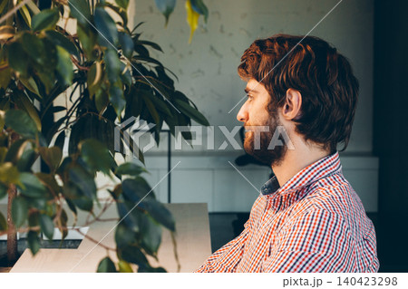 Bearded young businessman working at modern office Bearded young businessman working at modern office 140423298