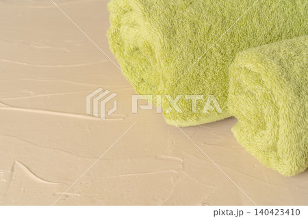 Pile of clean new towels against grey wall Pile of clean new towels against grey wall 140423410
