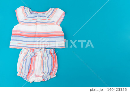 baby clothes on blue background top view baby clothes on blue background top view 140423526