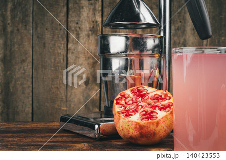Fresh pomegranate juice on wooden table close up 140423553