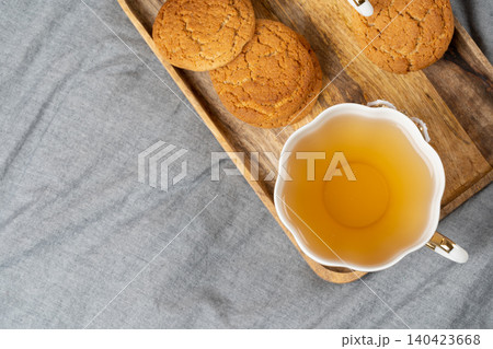 White porcelain cup of tea and oat cookies on a table 140423668