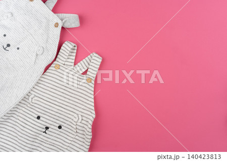 baby clothes on pink background top view 140423813