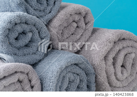 Stack of rolled towels on a wooden table Stack of rolled towels on a wooden table 140423868