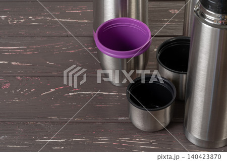 Aluminum metal thermos container bottle close up on table 140423870