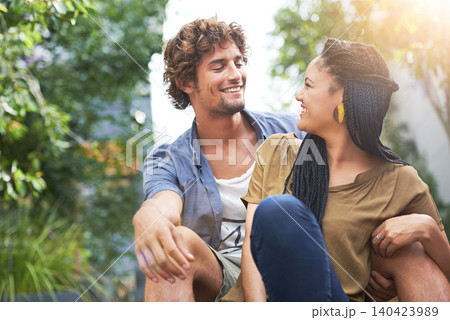 Interracial couple, outdoor and smile for summer, park and date together or bonding of boyfriend and girlfriend. Male and female person for nature, happy and love for outside as students or city life 140423989