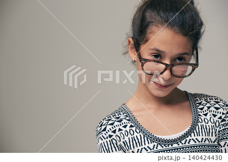 Girl, child and glasses in studio with space, thinking and mock up for style, vision and eye care by background. Kid, model and frame with eyesight, wellness and nerd for optometry in childhood Girl, child and glasses in studio with space, thinking and mock up for style, vision and eye care by background. Kid, model and frame with eyesight, wellness and nerd for optometry in childhood 140424430