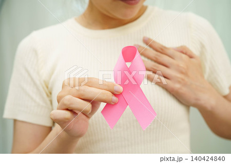 Asian woman with pink ribbon for October world breast cancer day. Asian woman with pink ribbon for October world breast cancer day. 140424840
