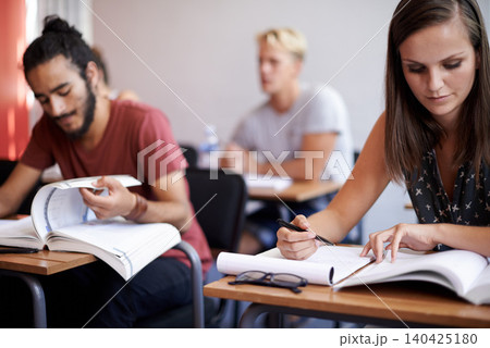 People, students and classroom with books for thinking, info and solution with education, studying and ideas. Man, woman and learning for exam with notes, pen and reading for development at college 140425180