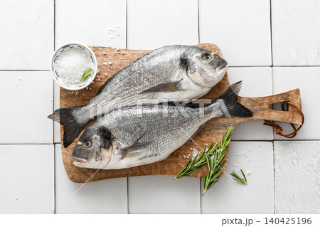 Fresh raw dorado fish cooking with ingredients. Sea bream, dorado. Seafood, healthy food. Top view Fresh raw dorado fish cooking with ingredients. Sea bream, dorado. Seafood, healthy food. Top view 140425196