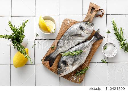 Fresh raw dorado fish cooking with ingredients. Sea bream, dorado. Seafood, healthy food. Top view 140425200