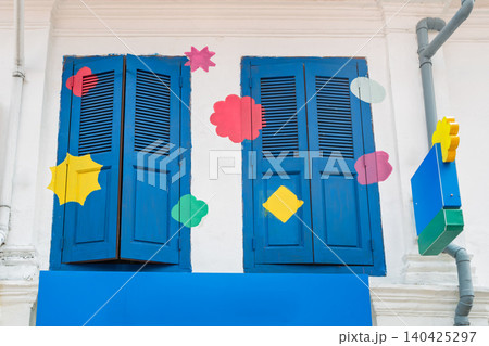 Blue wooden shutters on historic building with colorful decorations Blue wooden shutters on historic building with colorful decorations 140425297