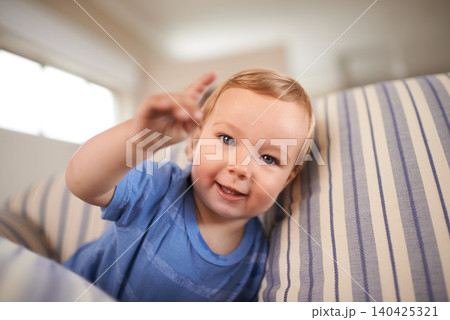 Toddler, playing and portrait of baby on couch in home for fun crawling or learning in living room. Happy, boy or face of a curious male kid on sofa for child development or growth in a house alone Toddler, playing and portrait of baby on couch in home for fun crawling or learning in living room. Happy, boy or face of a curious male kid on sofa for child development or growth in a house alone 140425321