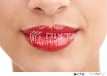Person, red lipstick and closeup of smile with makeup in cosmetics, gloss or glow in treatment. Colorful lips of woman or model in satisfaction for mouth, oral or beauty in cosmetology or dermatology Person, red lipstick and closeup of smile with makeup in cosmetics, gloss or glow in treatment. Colorful lips of woman or model in satisfaction for mouth, oral or beauty in cosmetology or dermatology 140425459
