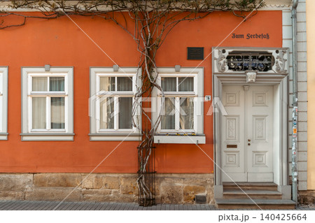 Historic Orange Facade With White Door and Windows in Germany Historic Orange Facade With White Door and Windows in Germany 140425664