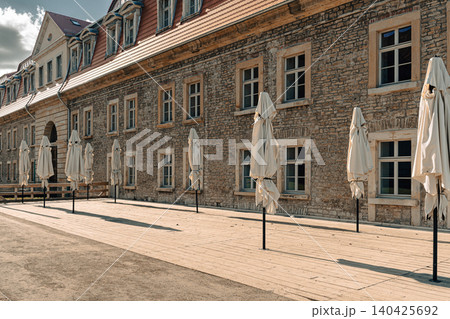 Erfurt, Germany - March 27, 2026. Historic Stone Building With Terrace Umbrellas 140425692