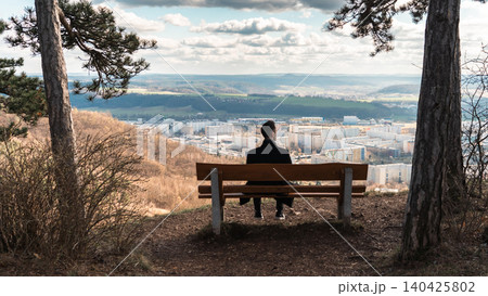Man Sitting on Bench Overlooking Valley Man Sitting on Bench Overlooking Valley 140425802