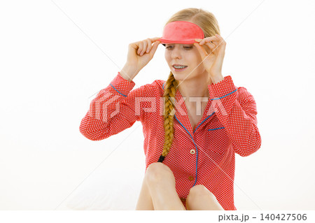 Sleepy woman wearing pink eye band Sleepy woman wearing pink eye band 140427506