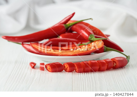 Fresh red chili peppers with on a white wooden table. Fresh red chili peppers with on a white wooden table. 140427844