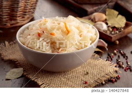Homemade sauerkraut with carrot on an old wooden table. 140427848