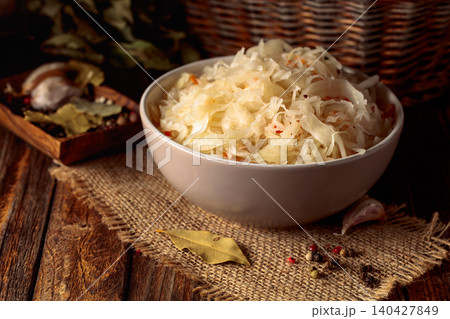Sauerkraut with ingredients on a rustic background. Sauerkraut with ingredients on a rustic background. 140427849