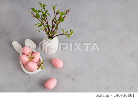 Easter holiday with pastel pink eggs, vase with branches Easter holiday with pastel pink eggs, vase with branches 140430861