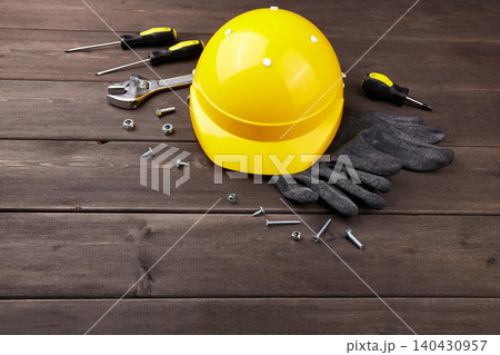 Happy labor day concept. Construction tools, yellow helmet on dark wooden background 140430957