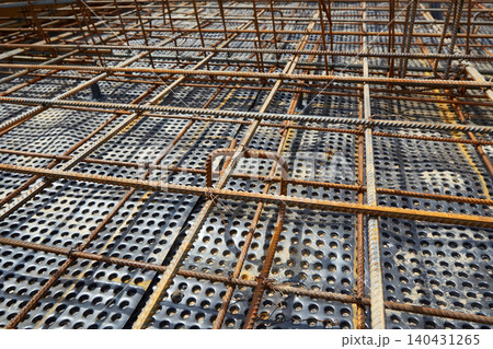 The construction of a concrete foundation using reinforcing steel prepared at the construction site The construction of a concrete foundation using reinforcing steel prepared at the construction site 140431265