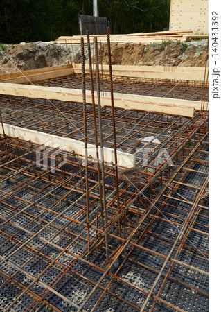 Steel reinforcement is placed in wooden molds and formwork on a construction site Steel reinforcement is placed in wooden molds and formwork on a construction site 140431392