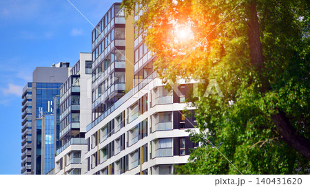 View of modern residential building with glass balconies and bright facade. Contemporary apartment building in european city. Concept of urban living and modern architecture. View of modern residential building with glass balconies and bright facade. Contemporary apartment building in european city. Concept of urban living and modern architecture. 140431620