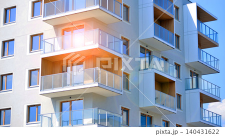 View of modern residential building with glass balconies and bright facade. Contemporary apartment building in european city. Concept of urban living and modern architecture.  140431622