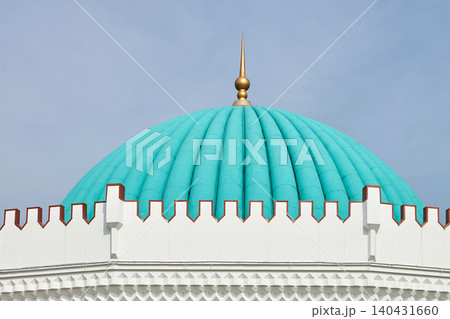 Turquoise ribbed dome of mosque. Traditional Islamic architecture with golden spire against clear blue sky. Travel destination and cultural monument heritage site. 140431660