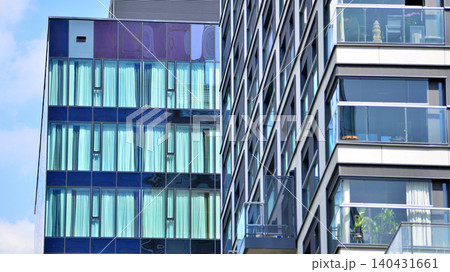View of modern residential building with glass balconies and bright facade. Contemporary apartment building in european city. Concept of urban living and modern architecture.  140431661