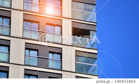 View of modern residential building with glass balconies and bright facade. Contemporary apartment building in european city. Concept of urban living and modern architecture.  140431663