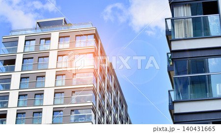 View of modern residential building with glass balconies and bright facade. Contemporary apartment building in european city. Concept of urban living and modern architecture. View of modern residential building with glass balconies and bright facade. Contemporary apartment building in european city. Concept of urban living and modern architecture. 140431665