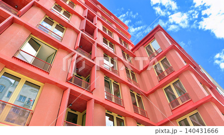 View of modern residential building with glass balconies and bright facade. Contemporary apartment building in european city. Concept of urban living and modern architecture. View of modern residential building with glass balconies and bright facade. Contemporary apartment building in european city. Concept of urban living and modern architecture. 140431666