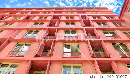 View of modern residential building with glass balconies and bright facade. Contemporary apartment building in european city. Concept of urban living and modern architecture. View of modern residential building with glass balconies and bright facade. Contemporary apartment building in european city. Concept of urban living and modern architecture. 140431667