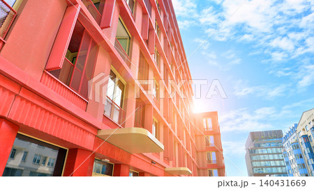 View of modern residential building with glass balconies and bright facade. Contemporary apartment building in european city. Concept of urban living and modern architecture.  140431669