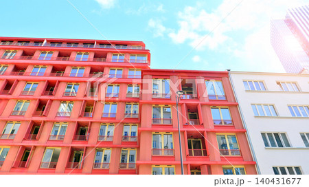 View of modern residential building with glass balconies and bright facade. Contemporary apartment building in european city. Concept of urban living and modern architecture. View of modern residential building with glass balconies and bright facade. Contemporary apartment building in european city. Concept of urban living and modern architecture. 140431677