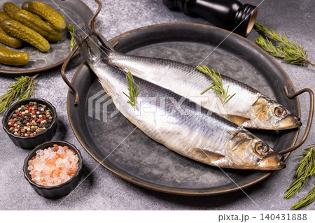 Salted herring fish with rosemary and pickles on rustic tray Salted herring fish with rosemary and pickles on rustic tray 140431888
