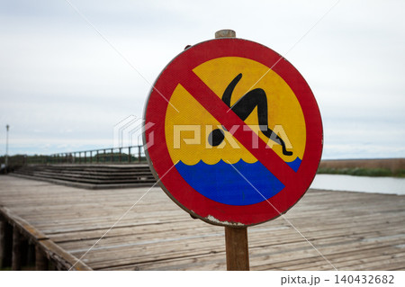 A sign informing about the prohibition of jumping into the water 140432682